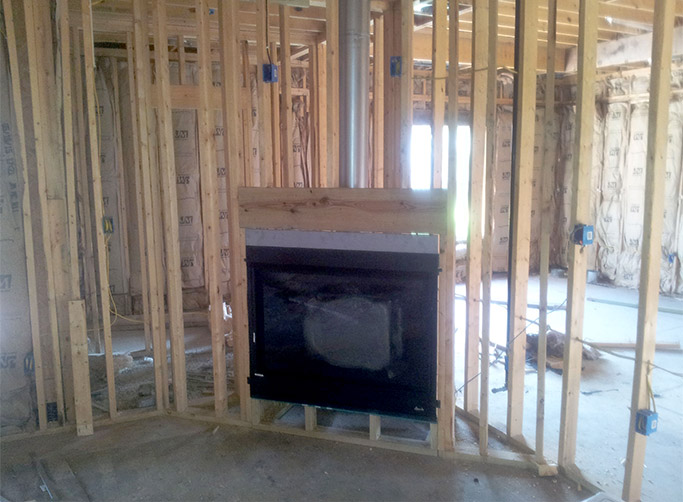 In this installation, a Superior DRT3045 direct vent fireplace has been installed into a corner enclosure.  Note the raised platform to allow for a hearth extension and the header that is installed to support the weight of the structure above the fireplace.